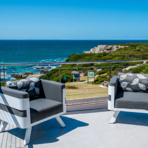 Terrace chairs at 7 On Marine looking over the cliff path and Walker Bay in Hermanus