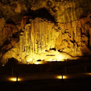 A lit chamber inside the Cango Caves showing large dripstone formations