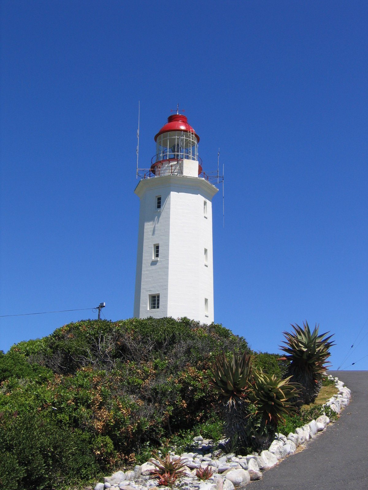 The white tower of Danger Point lighthouse above the fynbos south of Gansbaai