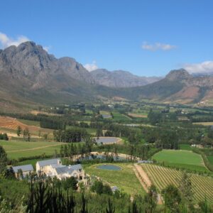 The Franschhoek valley floor under vineyards with the surrounding mountain wall behind