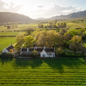 The white Cape Dutch manor house and vineyards of Grande Provence in the Franschhoek valley