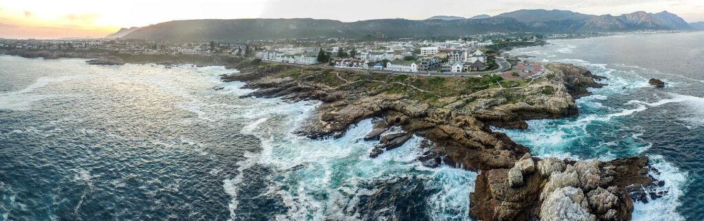 The rocky Hermanus shoreline and cliff path looking along Walker Bay