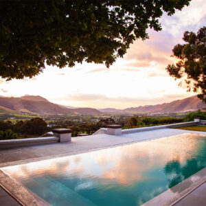 The infinity pool at La Petite Ferme at dusk looking down the Franschhoek valley from the Franschhoek Pass