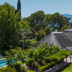 Thatched manor house, pool and gardens at Laborie Estate below Paarl Mountain
