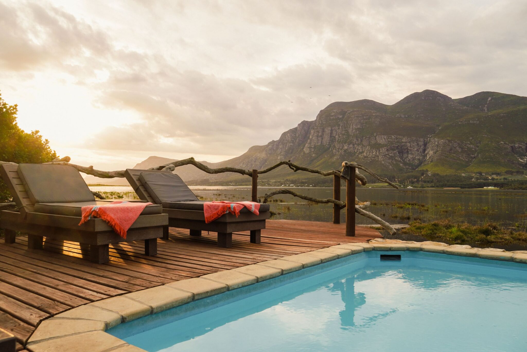 Pool deck at Mosaic Lagoon Lodge looking over the Klein River lagoon to the Kleinrivier mountains