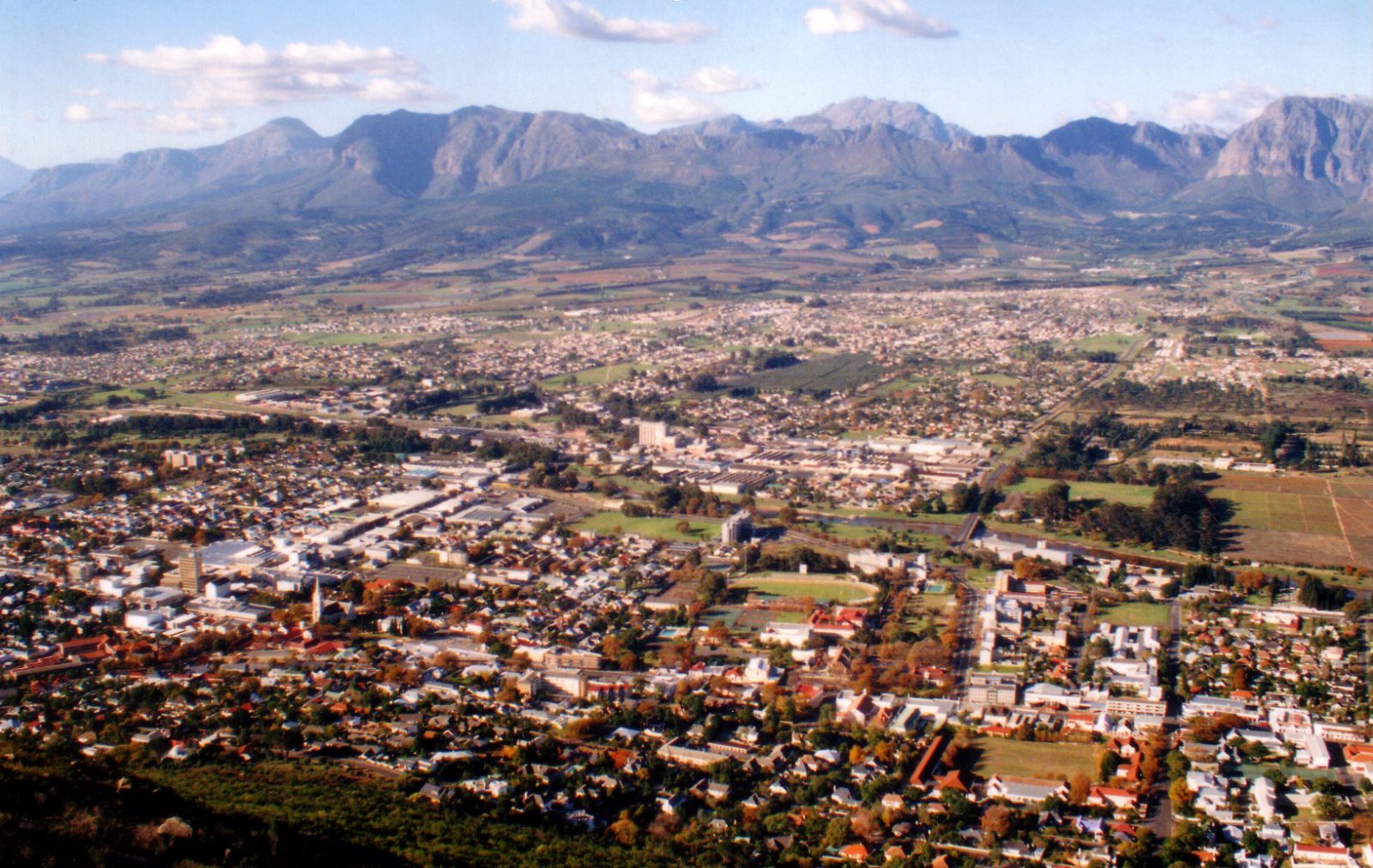 The town of Paarl spread across the valley floor with the Drakenstein mountains behind