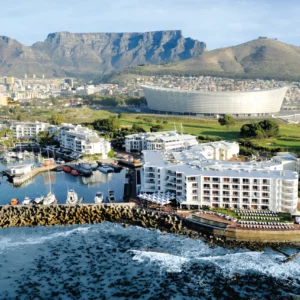 The Radisson Collection Hotel on the Waterfront breakwater in Cape Town seen from the air with the city behind