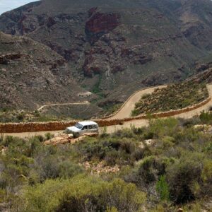 Gravel hairpin bends and dry-stone retaining walls on the Swartberg Pass