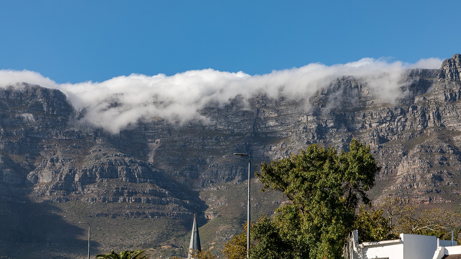 The front face of Table Mountain with its tablecloth cloud spilling over the plateau edge