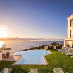 A view of a hotel with a swimming pool and the ocean at The Plettenberg Hotel in Plettenberg Bay