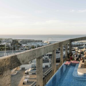The rooftop pool at The Silo Hotel looking out over the V&A Waterfront and Table Bay in Cape Town