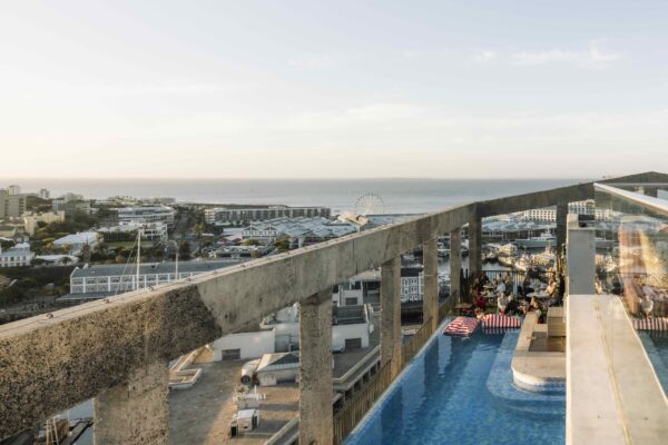The rooftop pool at The Silo Hotel looking out over the V&A Waterfront and Table Bay in Cape Town