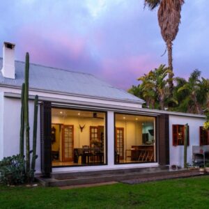 A house with large sliding glass doors in a yard at 22 Van Wijk Street Tourist Accommodation in Franschhoek