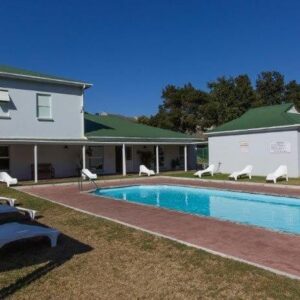 A house with a swimming pool next to a house at 31 Riverclub Villas in Plettenberg Bay