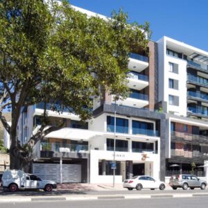 An apartment building with cars parked in front of it at 35 On Main by Stay In Luxury in Cape Town