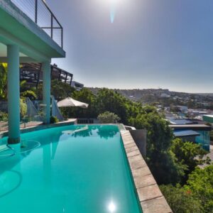 A swimming pool on the side of a house at 3ColoursBlue Guest House in Mossel Bay