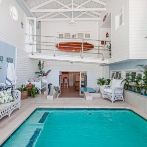 A house with a swimming pool and a patio at A Boat House in Simonʼs Town