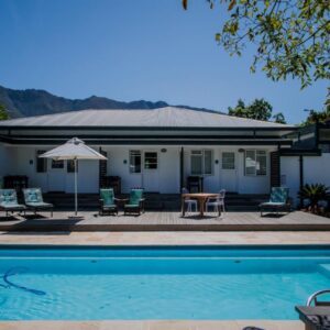 A swimming pool in front of a house at Aan de Eike Guest House in Swellendam