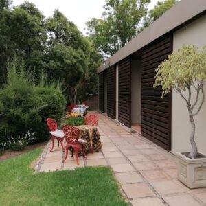 A garden patio beside the guest wing at Aanhuizen Guest House in Swellendam