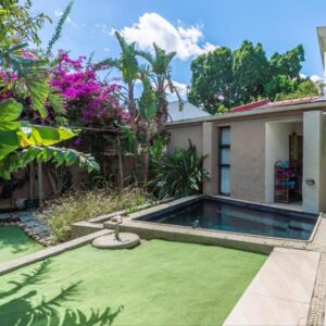A garden with a swimming pool in a house at Absolute Bosch Guest House in Stellenbosch
