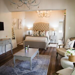 A bedroom with a bed and a living room at Afrika-Pearl in Paarl