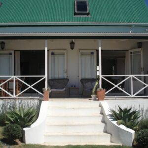 A house with a green roof and stairs at Aloe Cottage in Darling