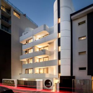 A tall white building with a car parked in front of it at Apartments by Morea Sea Point in Cape Town
