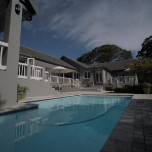 A swimming pool in front of a house at Arbour1 Guesthouse in George