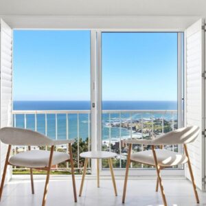 A dining room with a view of the ocean at Argaman View in Cape Town