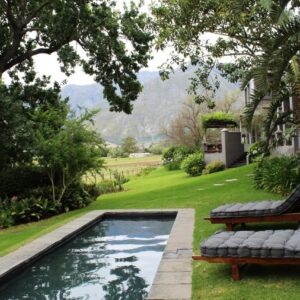 A backyard with a pool and a bench and a pool at Arumvale Country Retreat in Swellendam
