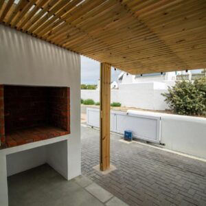 A living area with a fireplace on a patio at At51 Paternoster in Paternoster