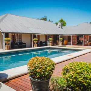 A swimming pool in front of a house at Atello Guesthouse in George