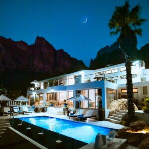 A villa with a swimming pool at night at Atlanticview Cape Town Boutique Hotel in Cape Town