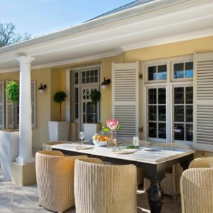 A patio with a table and chairs on a house at Auberge Daniella in Franschhoek