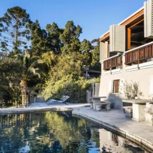 A swimming pool in front of a house at Avemore Manor House Le Verger in Stellenbosch