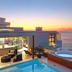 A house on the beach with a swimming pool at Azamare Guest House in Cape Town