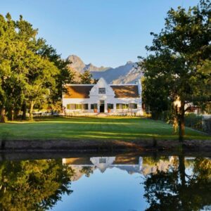 A house with a pond in front of it at Blaauwklippen Manor House & Jonkershuis by Newmark in Stellenbosch