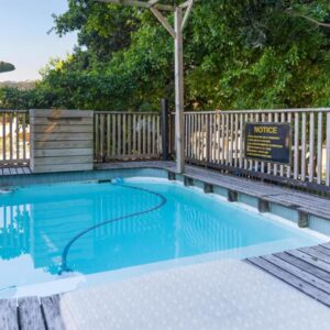 A small swimming pool with a wooden fence at Bliss in the Bay Guesthouse in Plettenberg Bay