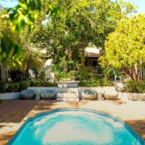 A swimming pool in a yard with trees at Blommenberg in Clanwilliam