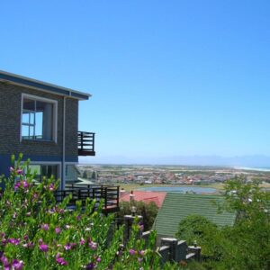A house with pink flowers in front of it at Bluebottle Guesthouse in Muizenberg