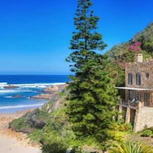 An old house on the beach next to a tree at Buccara Noetzie - Honeymoon Castle in Knysna