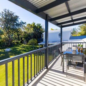 A patio with a table and chairs on a balcony at Burrough Place in George