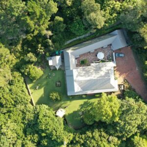 An overhead view of a house in the middle of a forest at BWHALE guest house B&B in Knysna
