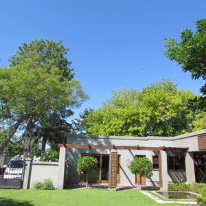 A house with a lawn and trees at Caledon 31 in George
