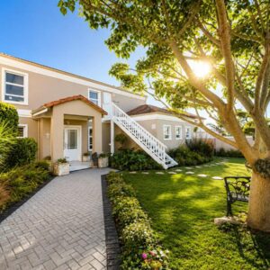 A house with a staircase in a yard at Calm Waters Guesthouse in Plettenberg Bay