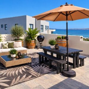 A patio with a table and an umbrella at Calypso Sunset Accommodation in Langebaan