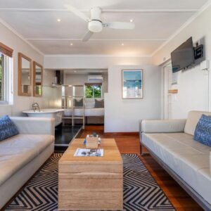 A living room with a couch and a table at Camps Bay Village - Village Apartments in Cape Town