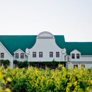 A large white house with a green roof at Cana Vineyard Guesthouse in Paarl