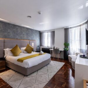 A hotel room with a bed and a desk at Cape Diamond Boutique Hotel in Cape Town