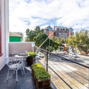 A balcony with a table and chairs and a street at Cape Town Heritage Hotel & Spa in Cape Town